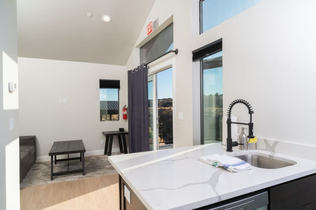 Modern kitchen interior with natural light and scenic view.