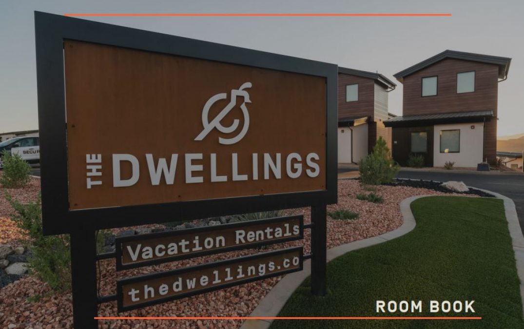 The Dwellings vacation rentals entrance sign with homes.