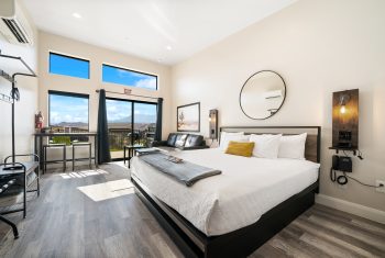 Modern bedroom with mountain view and stylish decor.