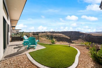Backyard patio with furniture and scenic canyon views.