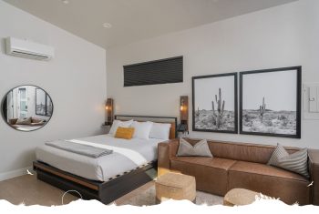 Modern bedroom with artwork and stylish furnishings.