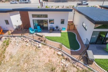 Modern house with backyard and artificial turf.