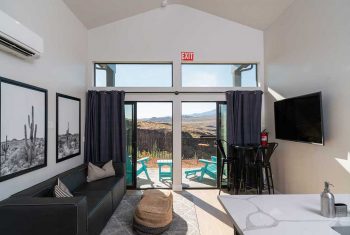 Modern room interior with mountain view and balcony.