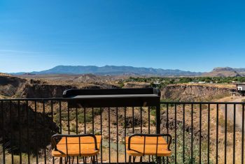 Scenic canyon view from outdoor terrace with chairs
