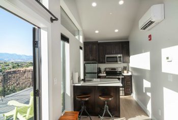 Modern kitchen interior with mountain view.