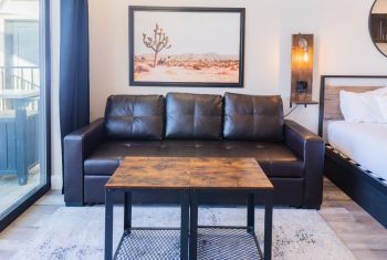 Modern living room with leather sofa and desert art.