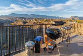 Outdoor barbecue area overlooking scenic mountains at sunset