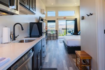 Modern studio apartment interior with mountain view.