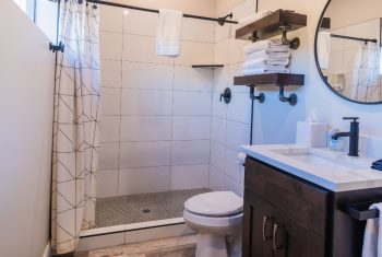 Modern bathroom interior with tiled shower area.